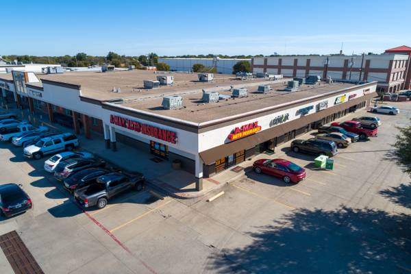 DFW real estate drone photography of a vibrant commercial shopping center.