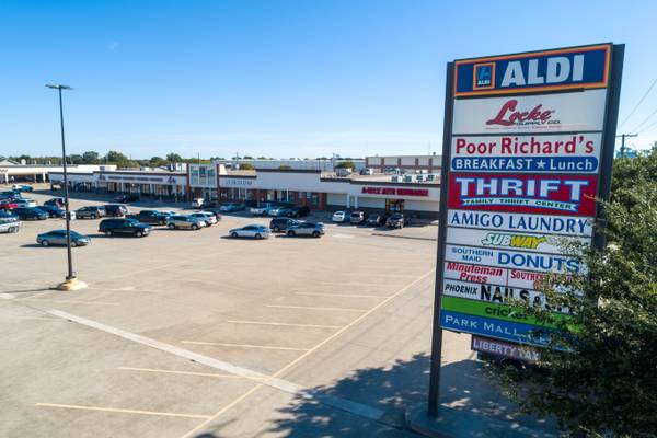 Commercial aerial drone photography of a vibrant retail plaza in DFW.
