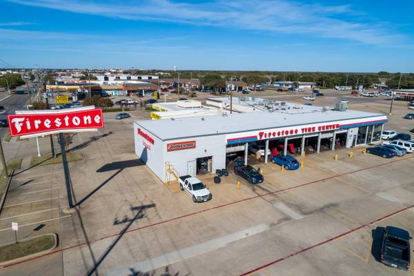 High-angle commercial drone photography of a bustling DFW retail property.